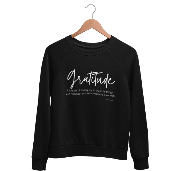 Cozy gratitude black sweatshirt with hand-lettered “Gratitude” definition graphic, part of a charity collection that provides 50 meals for U.S. Veterans.