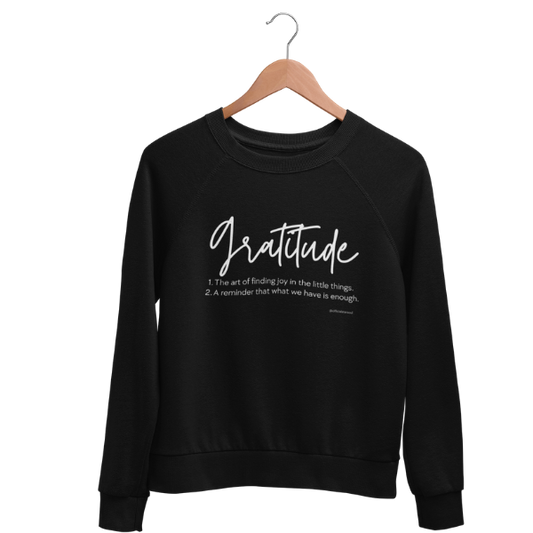 Cozy gratitude black sweatshirt with hand-lettered “Gratitude” definition graphic, part of a charity collection that provides 50 meals for U.S. Veterans.