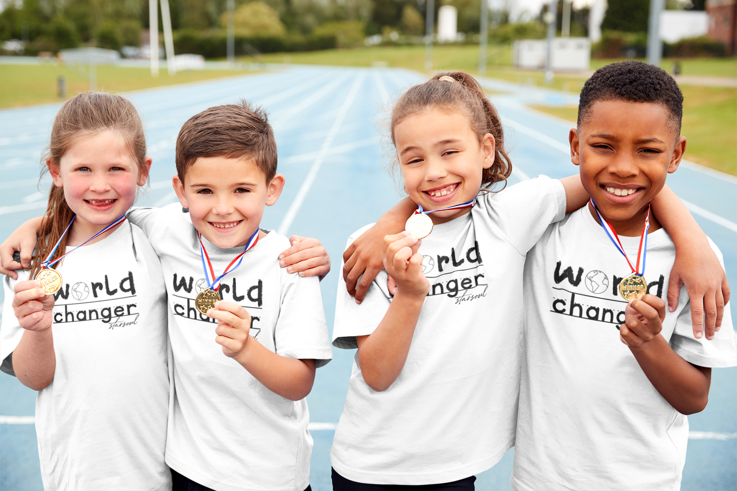 A group of kids wearing white t-shirts that say 'world changer' all proceeds are donated to charity