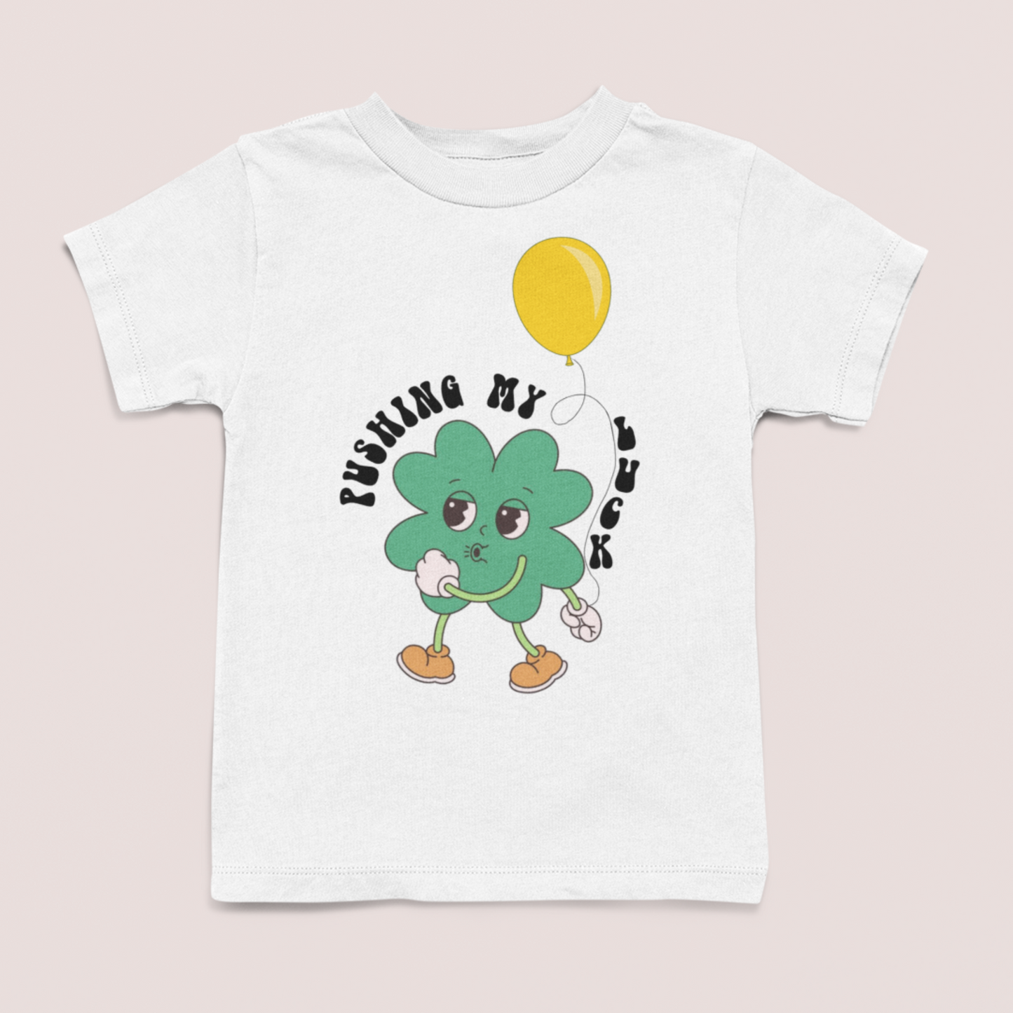 Charity t-shirt subscription box. All proceeds from each item support The National Diaper Bank Network, which provides basic necessities to children, families, and individuals in need. 1 in 2 U.S. families struggle with diaper needs - the NDBN wants to fill that gap and we want to help them do that. white tshirt with cute clover character holding balance, text: "pushing my luck", part of Lucky charity collection all proceeds donated to National Diaper Bank