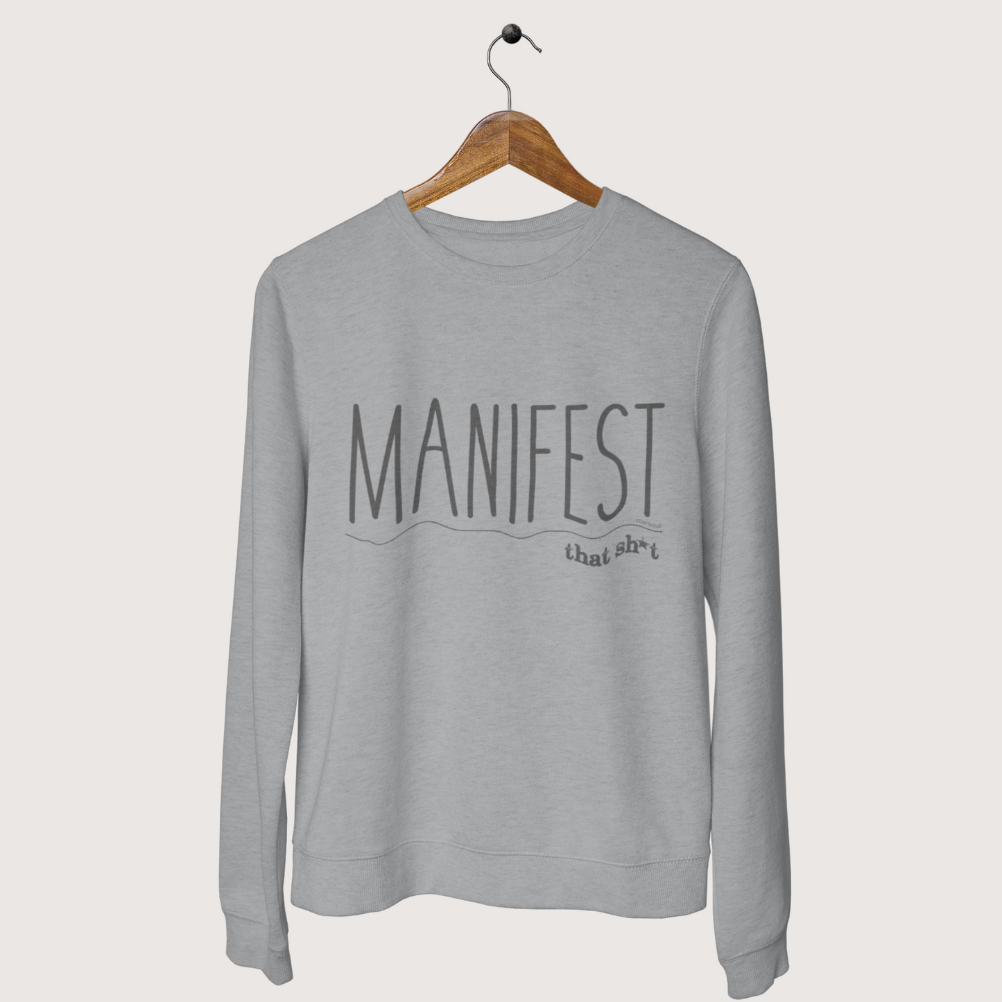 Manifest That Sh*t Sweater designed to make a bold statement. Look good while doing good giving back to kids with every purchase through Toys-for-Tots.
