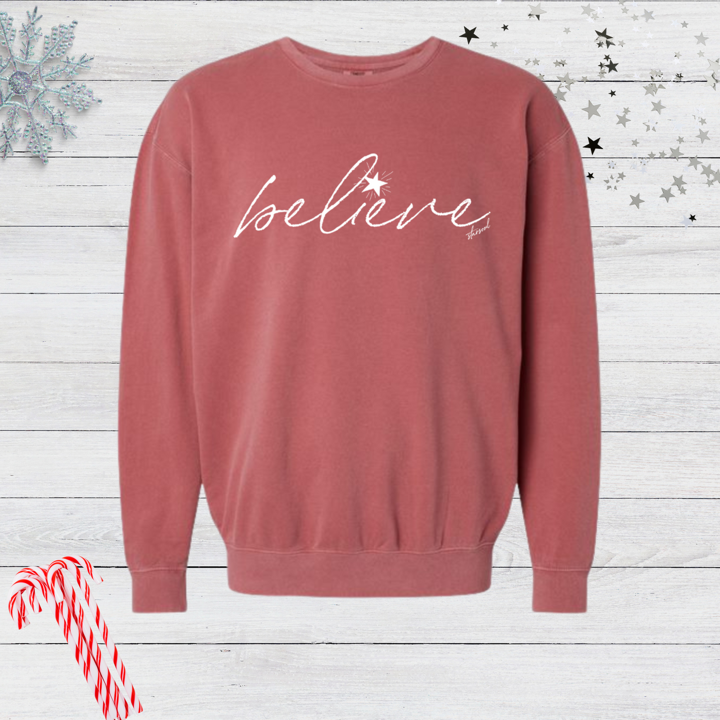 crimson vintage wash sweatshirt with red imprint "believe" on the front in cursive