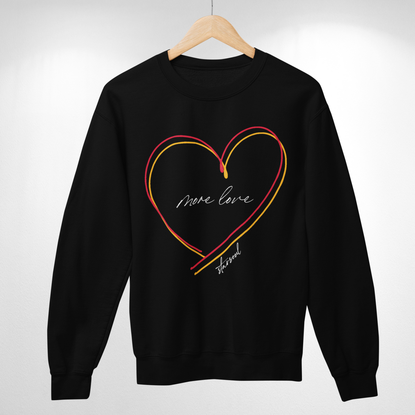 black sweatshirt with yellow and red heart (text: more love).Every purchase from the #KCstrong collection donates 100% of the proceeds to the Kansas City Strong emergency fund created by the Chiefs and the United Way of Kansas City.