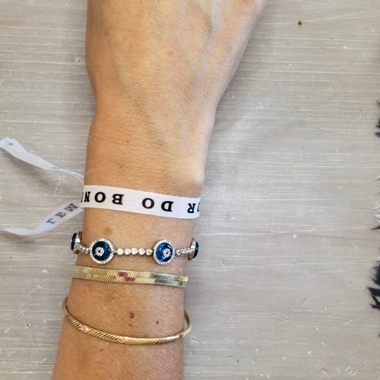 Brazilian bonfim bracelet for wishes, good luck, karma. All proceeds go to charity. Photo: white bracelets