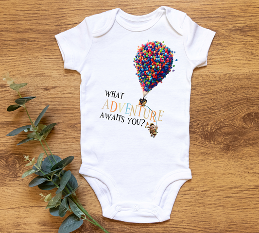 Charity t-shirt subscription box. All proceeds from each item support&nbsp;Lotus House&nbsp;Women's Shelter, the largest women's homeless shelter in the country housing over 1,550 women and children annually. White shirt with Up house balloons that says "what adventure awaits you?"