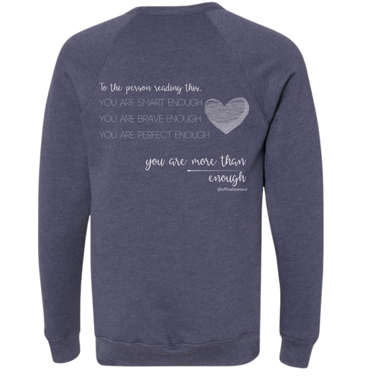 Navy sweatshirt with motivational quote on the back against a white background